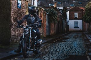 Man on motorbike in a lane with Planet Knox clothing