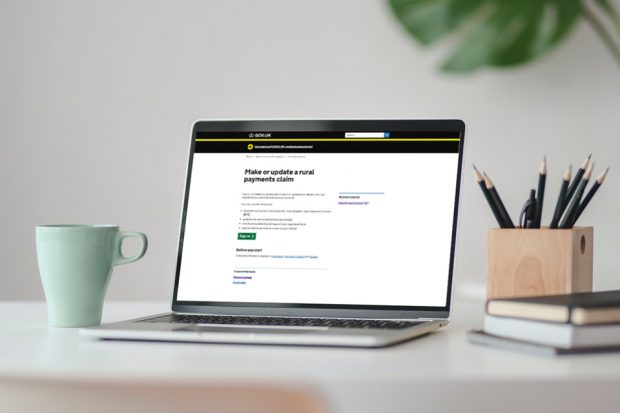 Open laptop on a desk with the screen showing the 'Make or update a rural payments claim' page on GOV.UK