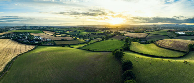 sunset over farmlands and fields from a drone in Devon, England
