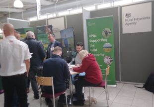 people sat round a table at an event stand