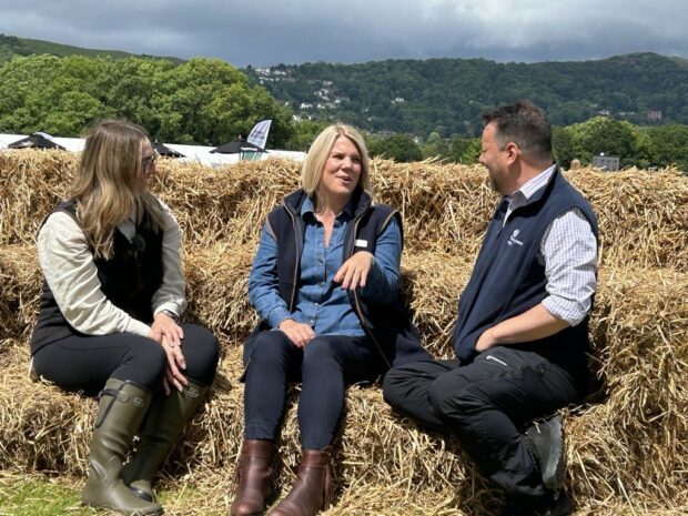 Marie, Gareth and Emily sit on hay bales for their interview