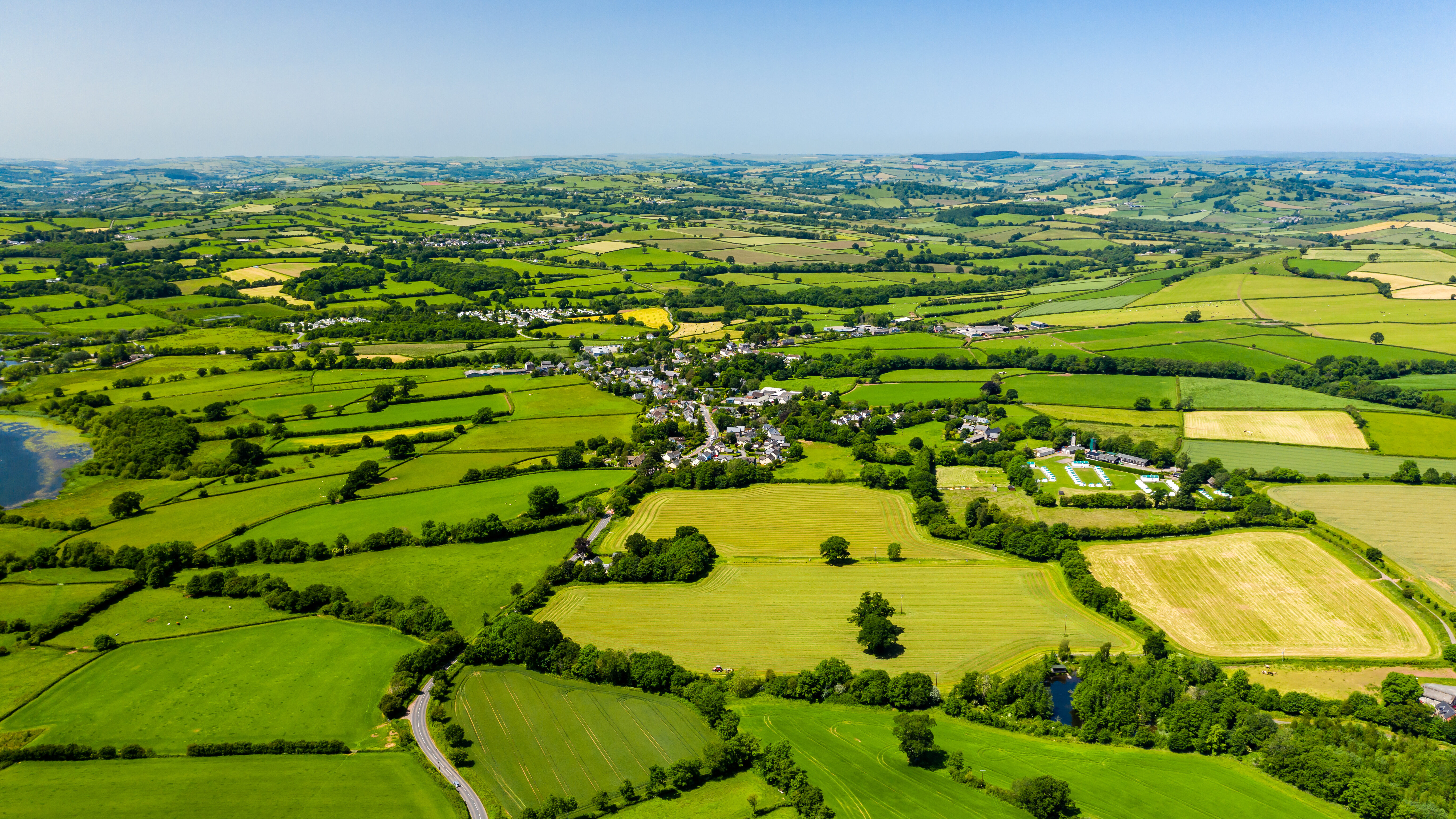 Aerial drone view of green fields and farmland